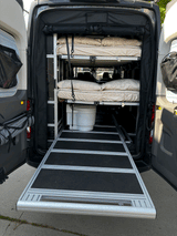 Explore this RV rental's versatile camper van interior: modular beds, portable toilet, and handy pull-out ramp.