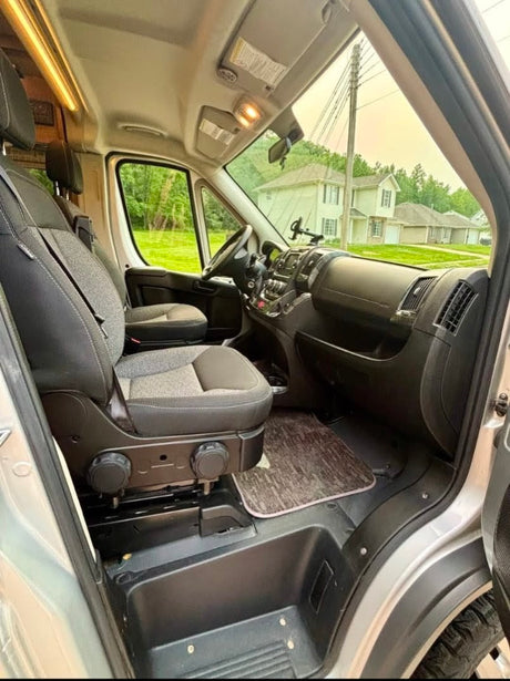 Spacious front cab of an RV rental, showing comfortable seating, dashboard, and a clear view for your next adventure.