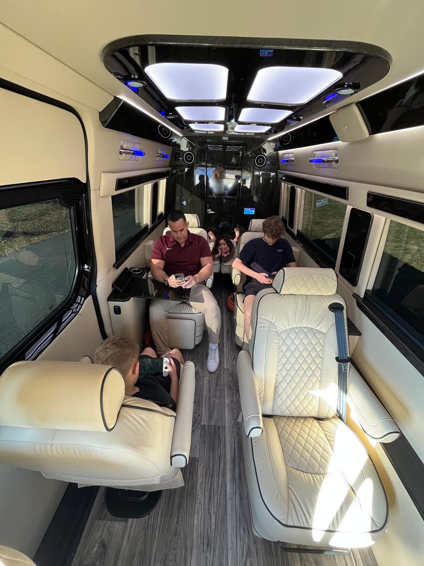 Family enjoys a spacious, modern RV rental interior, complete with comfy seats & entertainment.