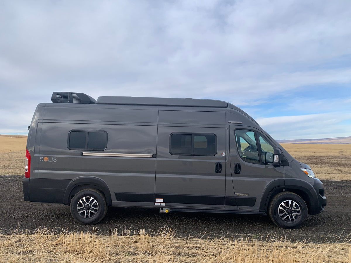 A sleek gray Winnebago Solis camper van