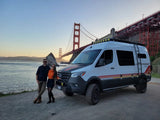 Adventure awaits! Couple & their Storyteller Overland RV rental at the Golden Gate Bridge. Perfect for van life travel.