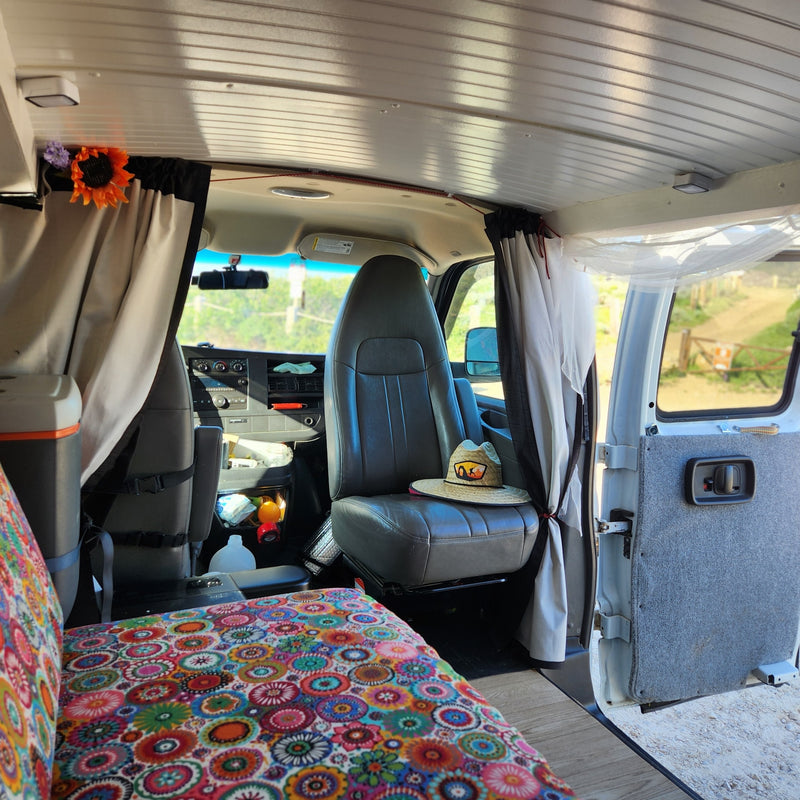 Explore this customized RV rental interior featuring a vibrant bed, front cabin, & cozy curtains. — photo 17