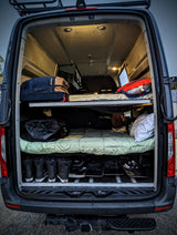 RV rental van interior: organized bunk beds, ample gear storage for snowboards & boots. Ready for adventure travel.