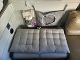 Cozy RV rental interior with Dometic cooler, comfy seating, and hanging organizers for essentials.