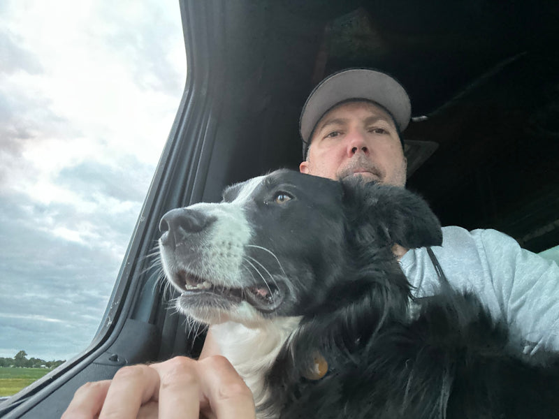 Travel buddy! Man and black & white dog enjoying the view from their RV rental window on a cloudy day. Adventure awaits. — photo 19