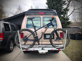Tan RV rental with a Kona mountain bike on a hitch rack. Ready for off-road adventures!