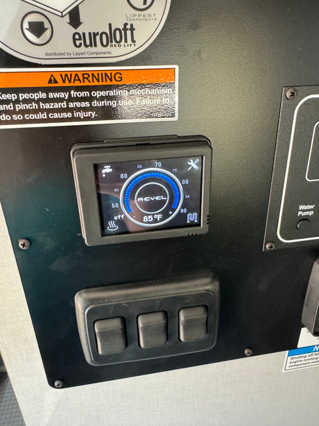 An RV rental control panel: Digital display shows 85°F water temperature, heating status, and warning for bed lift mechanism.