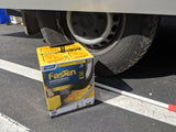 Fasten leveling blocks offer stability next to an RV rental tire, ideal for ensuring a level park on uneven ground.