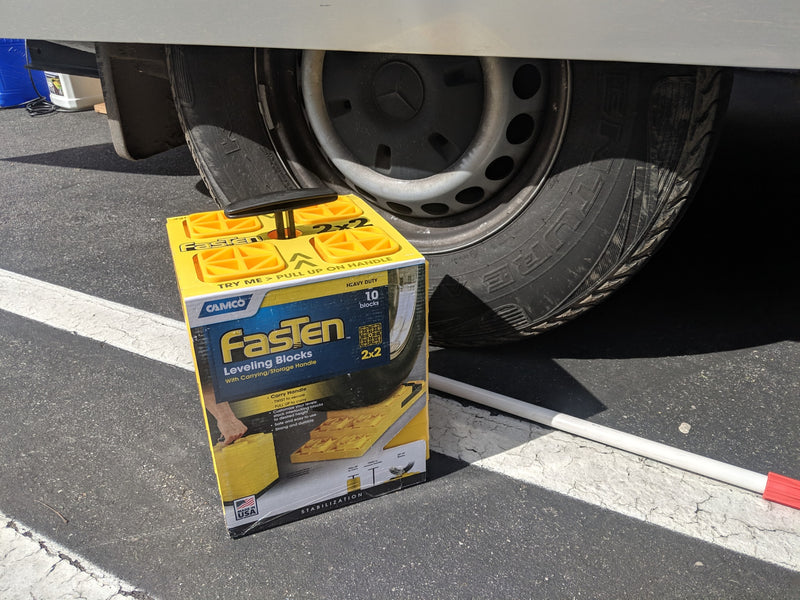 Fasten leveling blocks offer stability next to an RV rental tire, ideal for ensuring a level park on uneven ground. — photo 16
