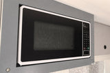 Built-in microwave in an RV rental kitchen setup. Prepare quick meals during your trip.