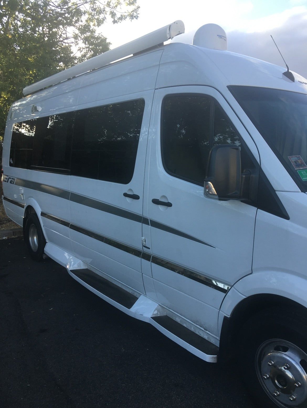 White Sprinter-style RV rental with an awning & satellite dish, ready for your next road trip. — photo 5