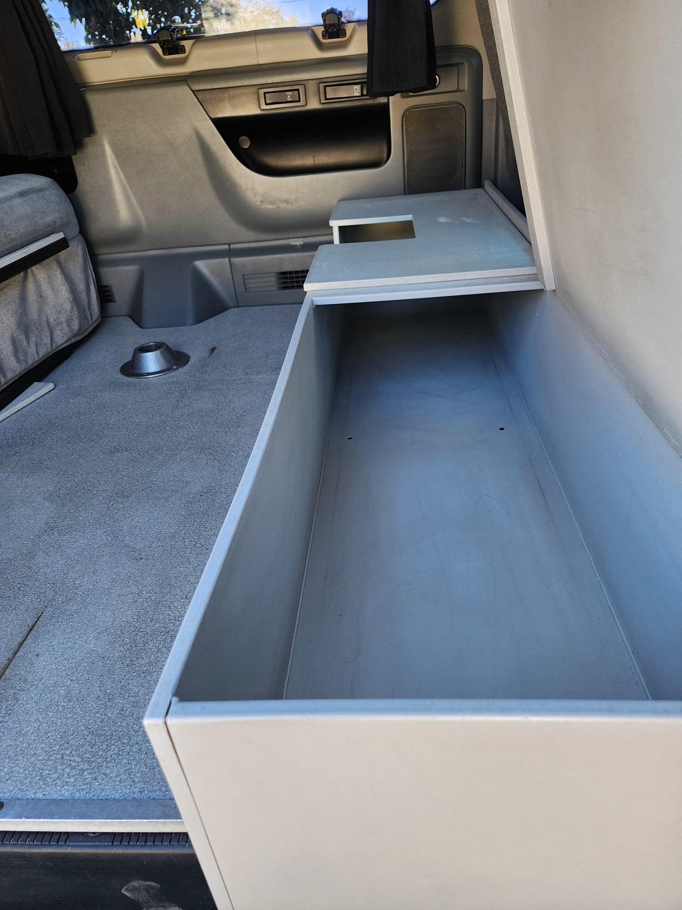  and cooler. Perfect for an RV rental adventure!|This RV rental camper van features a clever kitchen setup with a Coleman propane stove — photo 1