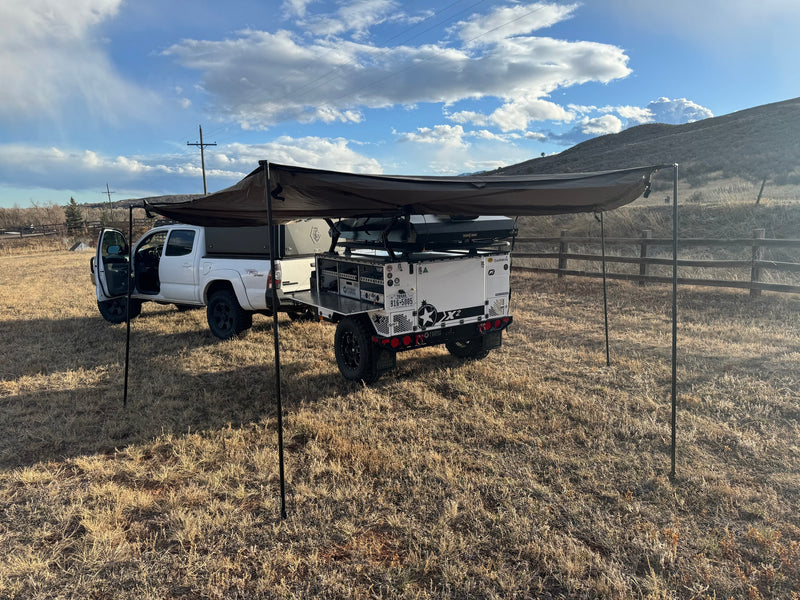 White truck & Patriot Campers X2 trailer with extended awning, parked in a field, ready for RV rental adventure. — photo 8
