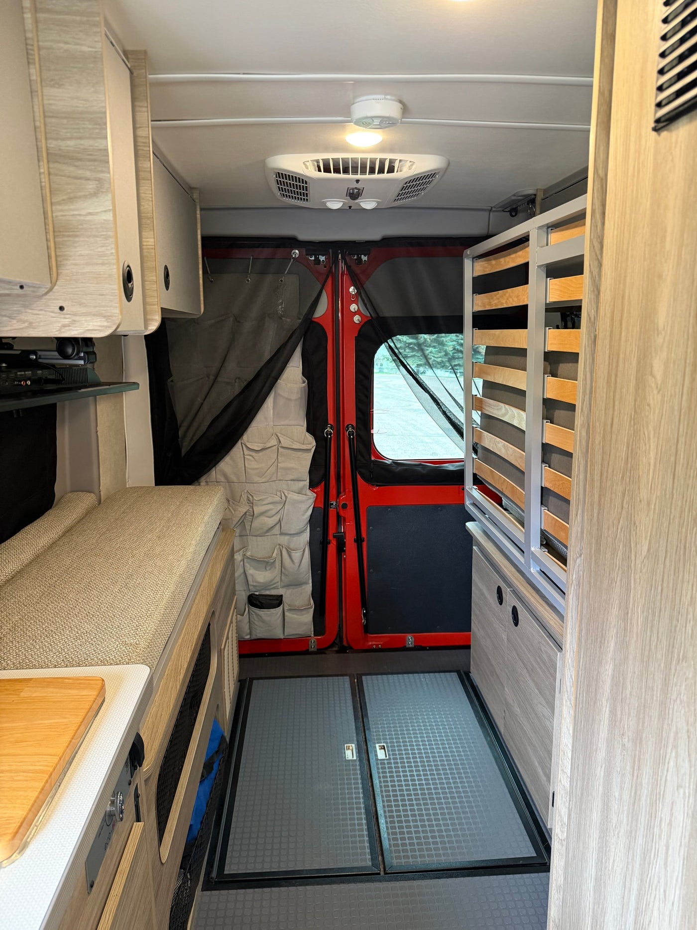  and flexible seating areas.|RV rental interior featuring a compact kitchen with sink — photo 9