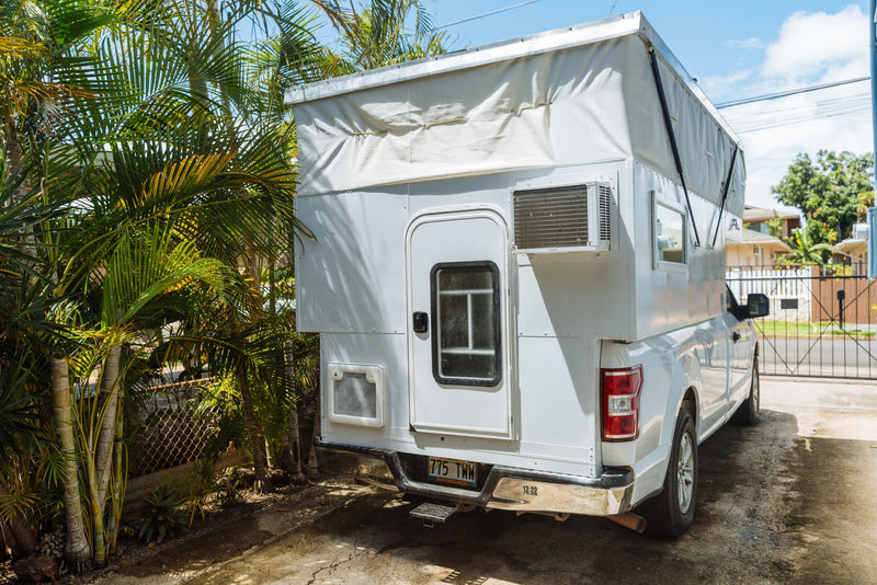 White truck with custom pop-top RV rental camper and AC unit — photo 1