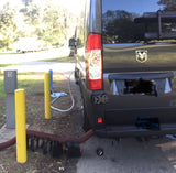 An RV rental (campervan) is parked at campsite 15, displaying full hookups with power, water, and a deployed sewer hose.
