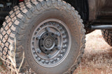 Close-up of a dirt-covered BFGoodrich Mud-Terrain tire on a Black Rhino wheel, ready for your RV rental adventure.
