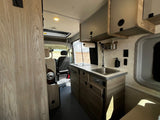 Step inside this cozy RV rental with a fully equipped kitchen and comfortable living area for memorable travels.