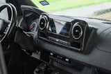RV rental interior dashboard: Modern design with a multi-function steering wheel, infotainment screen (SiriusXM), and climate controls.