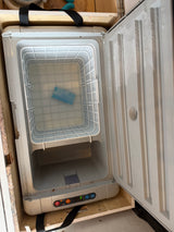 Open, frosty portable fridge/freezer for rv rental, showing empty basket, ice pack, and control panel.