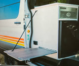 RV rental: Camper van with an integrated mobile kitchen, featuring a fold-down table, grill, and fridge.
