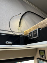 Cozy RV rental pop-top bed area with reading light, USB ports, and Truma control for comfort and convenience.