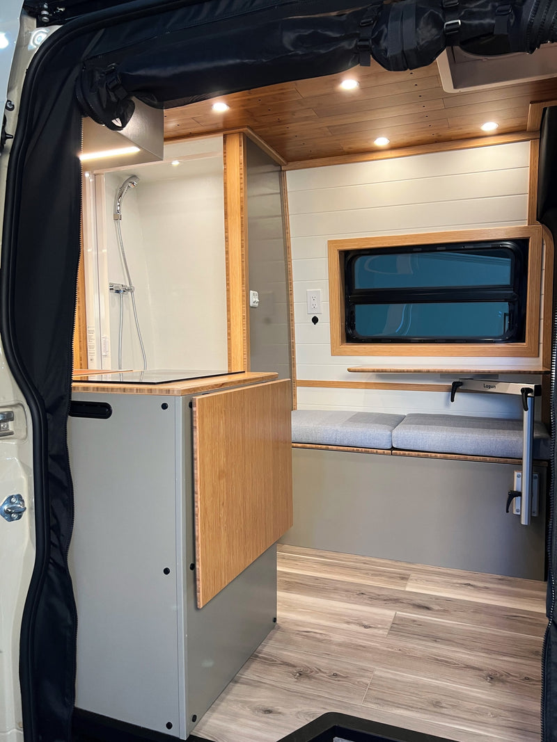  with a mesh screen revealing its functional and warm wooden interior.|Modern camper van RV rental interior: kitchen — photo 5