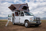 White Ford campervan with a rooftop tent deployed and ladder extended, perfect for your next RV rental adventure.