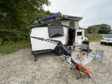 Your next rv rental adventure awaits! This compact pop-up camper offers cozy outdoor living with a comfortable setup.