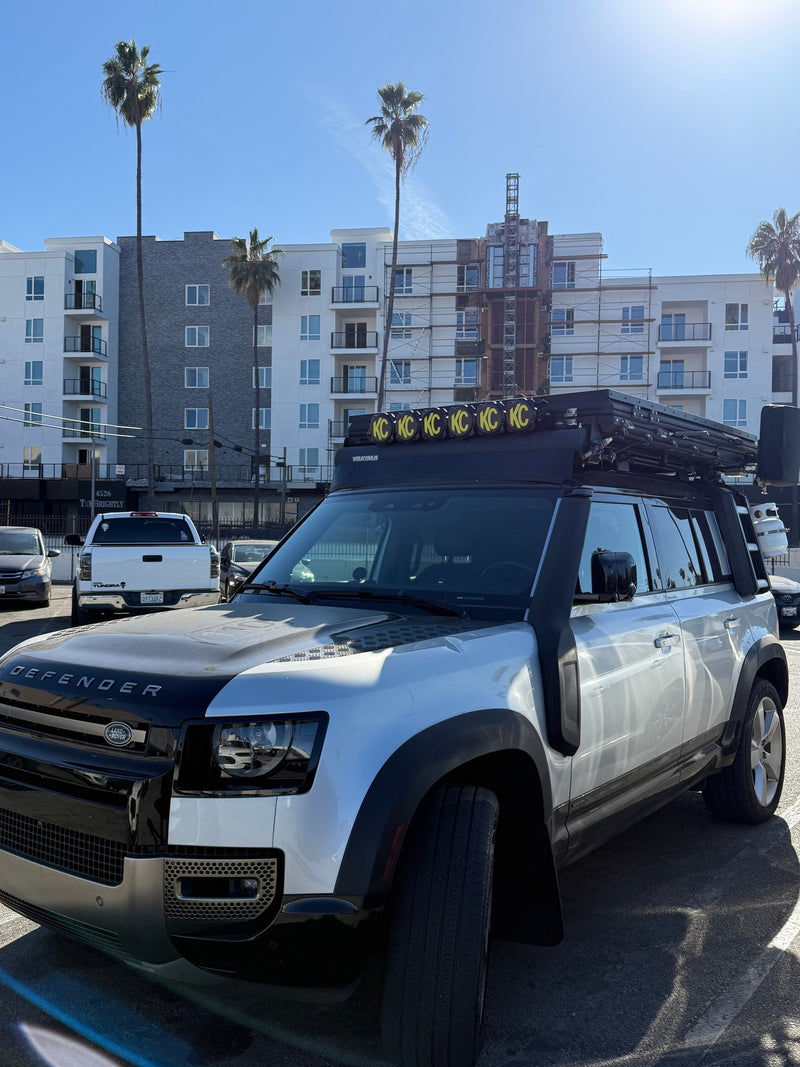 Silver Land Rover Defender with rooftop tent & overlanding gear; a unique option for an RV rental adventure. — photo 9