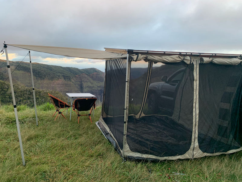  and string lights.|Compact RV rental setup: SUV with attached tent for outdoor camping on a sunny lawn — photo 7