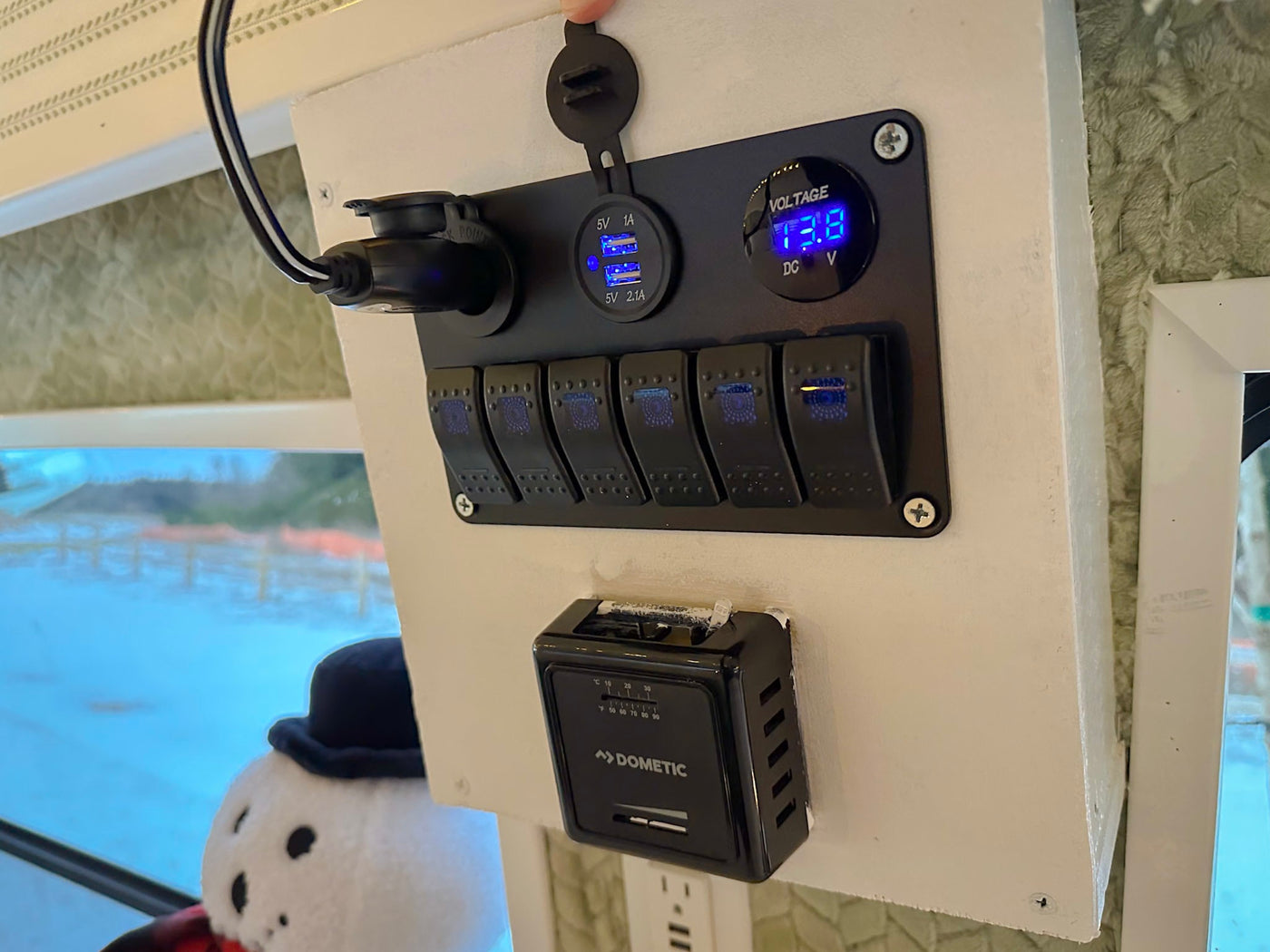  and a table. Perfect for a holiday getaway!|Experience cozy winter travels in this festive RV rental. Bright interior with snowflake lights — photo 14