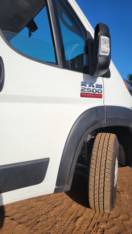 White Ram 2500 ProMaster van, an excellent RV rental, parked on dirt with a visible dirty tire.