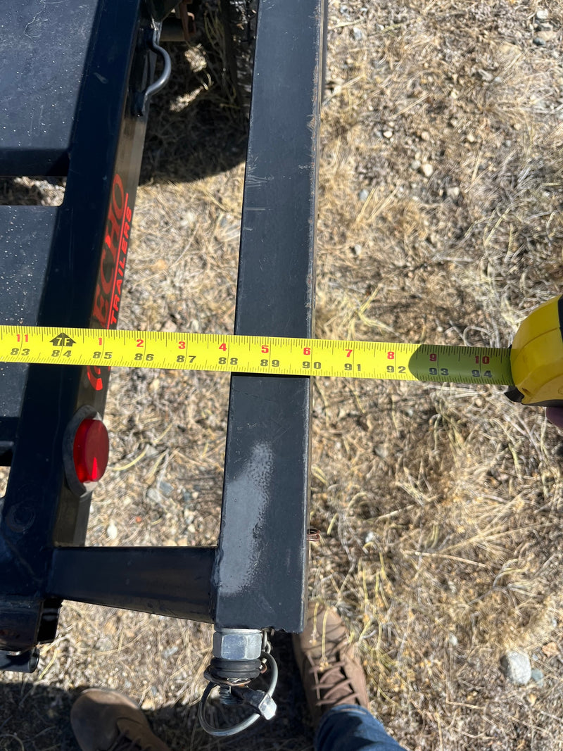 An RV rental trailer beam measured at 94 inches with a tape measure, showing ECHO TRAILERS branding. — photo 4