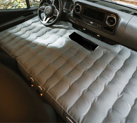 Perfect for an rv rental adventure: a comfortable inflatable mattress converts the front of this vehicle into a spacious car camping bed.