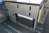 RV rental interior: Dometic CFX fridge on slide-out, modular cabinets, and fold-down table for adventure.