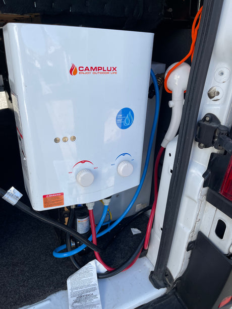 RV rental featuring a CAMPLUX portable tankless water heater and shower setup for convenient outdoor hot water.
