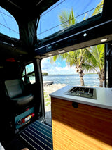 Enjoy coastal views from your RV rental! This camper van features a pop-top, kitchen, and stunning waterfront access.