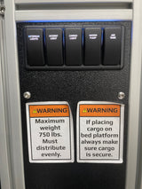 RV rental control panel showing light/pump/air switches & cargo weight/secure warnings for safe operation.