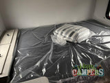 RV rental ready: A new, plastic-covered bed and pillow inside, awaiting happy campers.