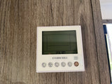 An EVERCHILL thermostat in an RV rental, with a digital display showing 23:30. Mounted on a wood-grain wall, with control buttons.