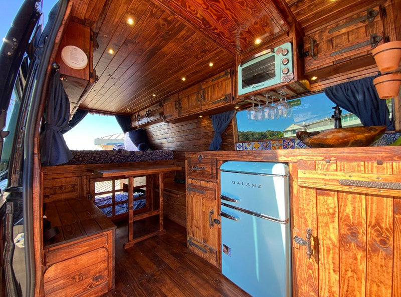  and dining. Ideal for van life.|This RV rental offers a custom wood interior with bunk beds — photo 5