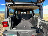 Spacious open rear cargo area of a Jeep Wrangler 4xe, ready for an RV rental adventure or outdoor trip with ample gear storage.