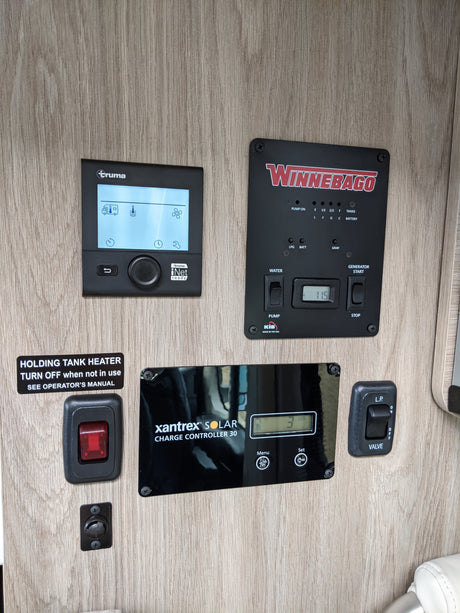 RV rental control panel for essential systems: tank levels, heating, solar charging, generator, and LP gas valve.