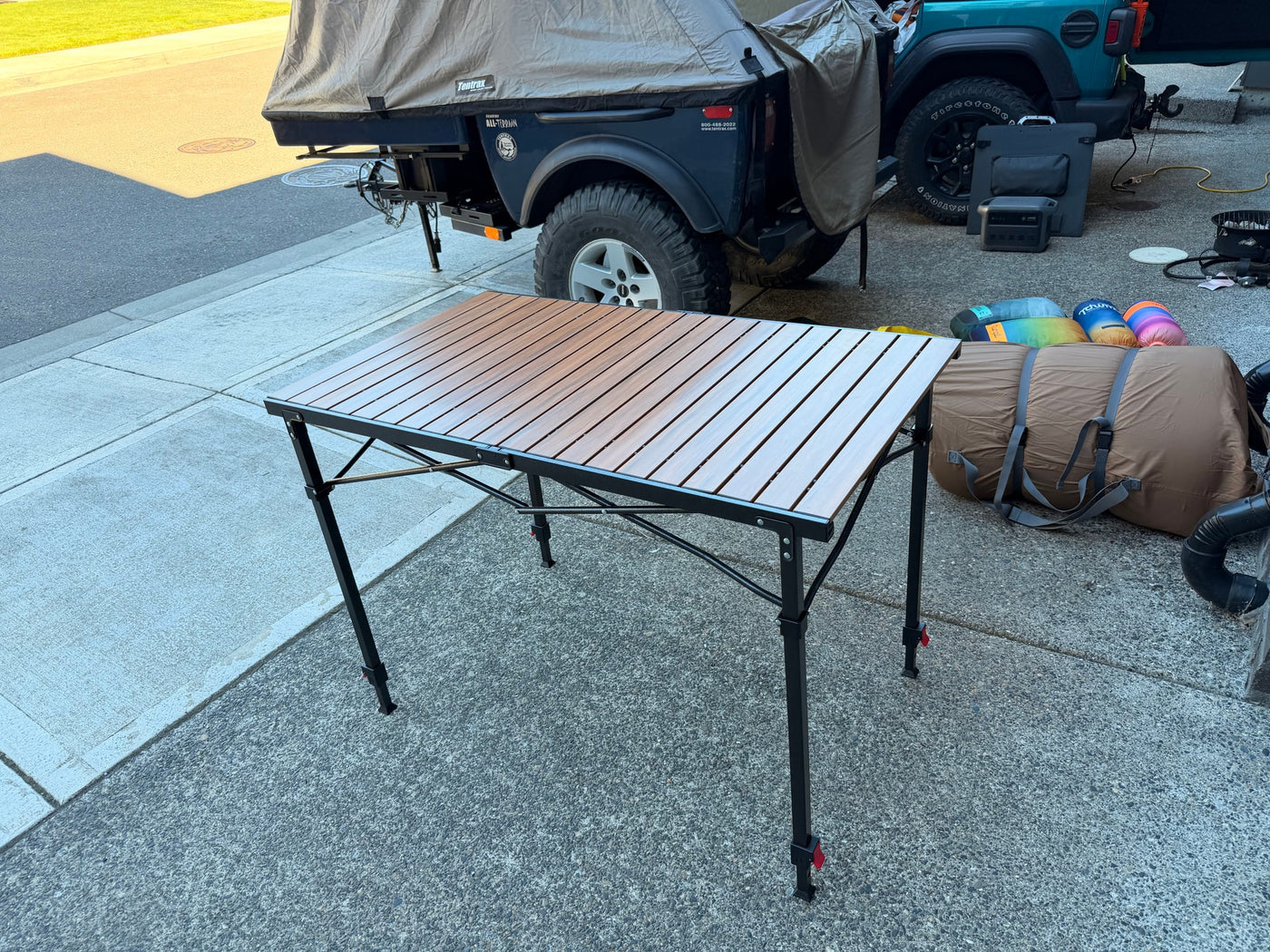 Portable camping table, off-road RV rental trailer, and gear for a campsite setup. Adventure awaits! — photo 11