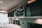 Explore this RV rental's smart campervan interior, featuring a pull-out shower, comfy bed, & scenic window view.