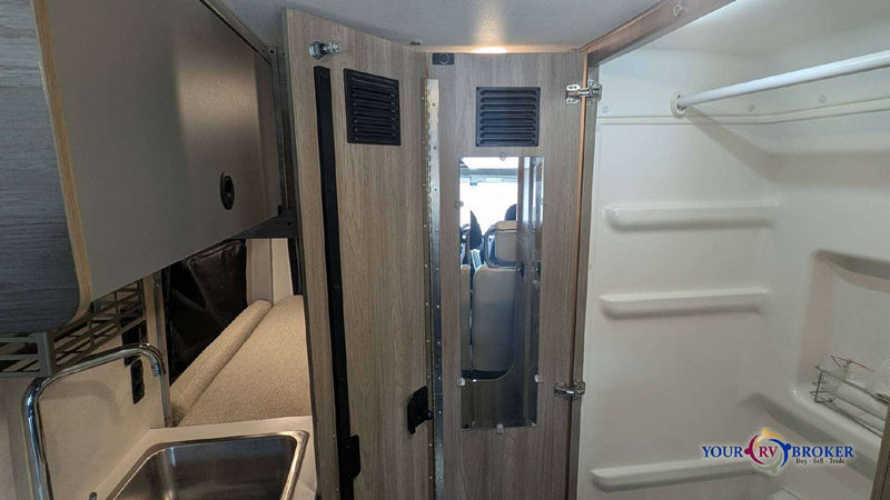  and control panel in a modern camper van living space.|This RV rental camper van interior features a control panel — photo 8