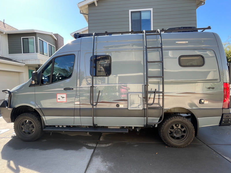 Adventure-ready gray camper van with ladder & roof rack. Ideal for your next RV rental road trip. — photo 2