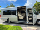 Luxury silver Mercedes Sprinter RV rental van. Open side door reveals a spacious, plush cream interior for travel.
