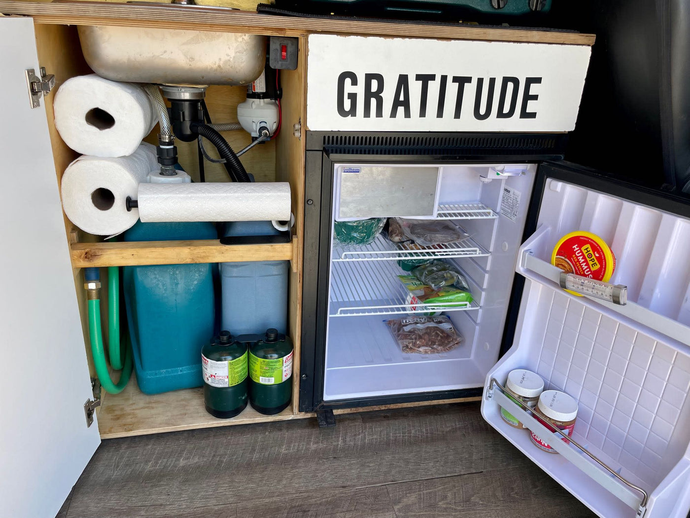  minimalist interior. Ideal for van life travel.|Cozy RV rental interior with compact kitchen — photo 9